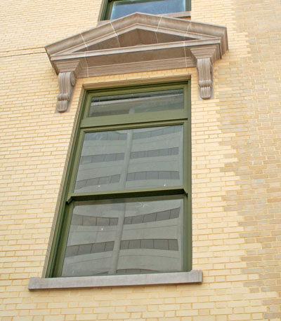 The windows and most of the brick on the east side of the building (pictured here) had to be replaced, but some original brick (on the right) was restored. 