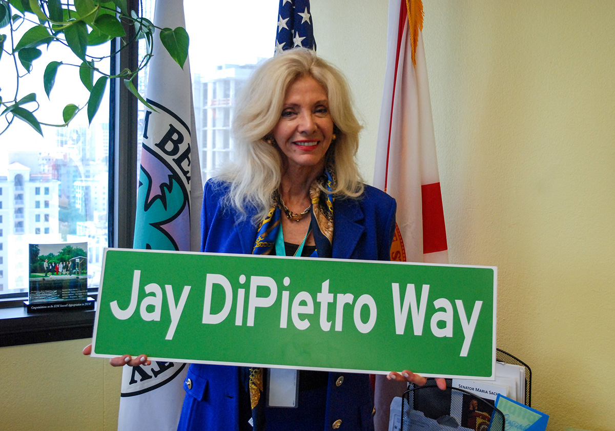 Commissioner Sachs posing with the new Jay Dipietro road sign