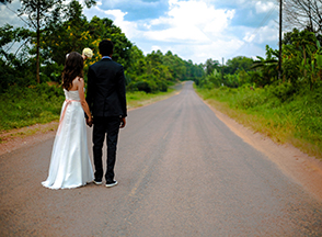 Back of Bride and Groom looking down a deserted road.