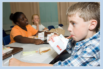 child drinking milk in cafeteria