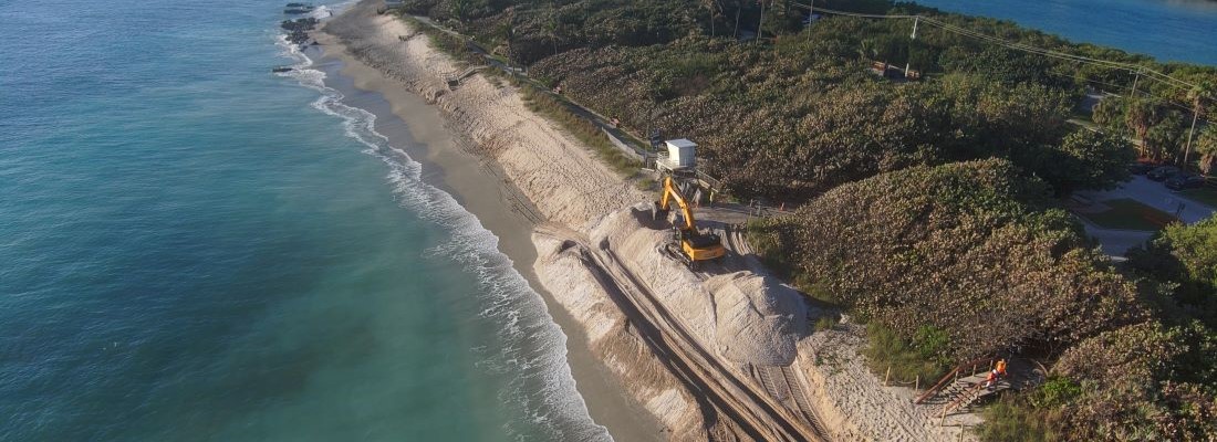 Sand being formed into a natural beach dune profile at Coral Cove beach