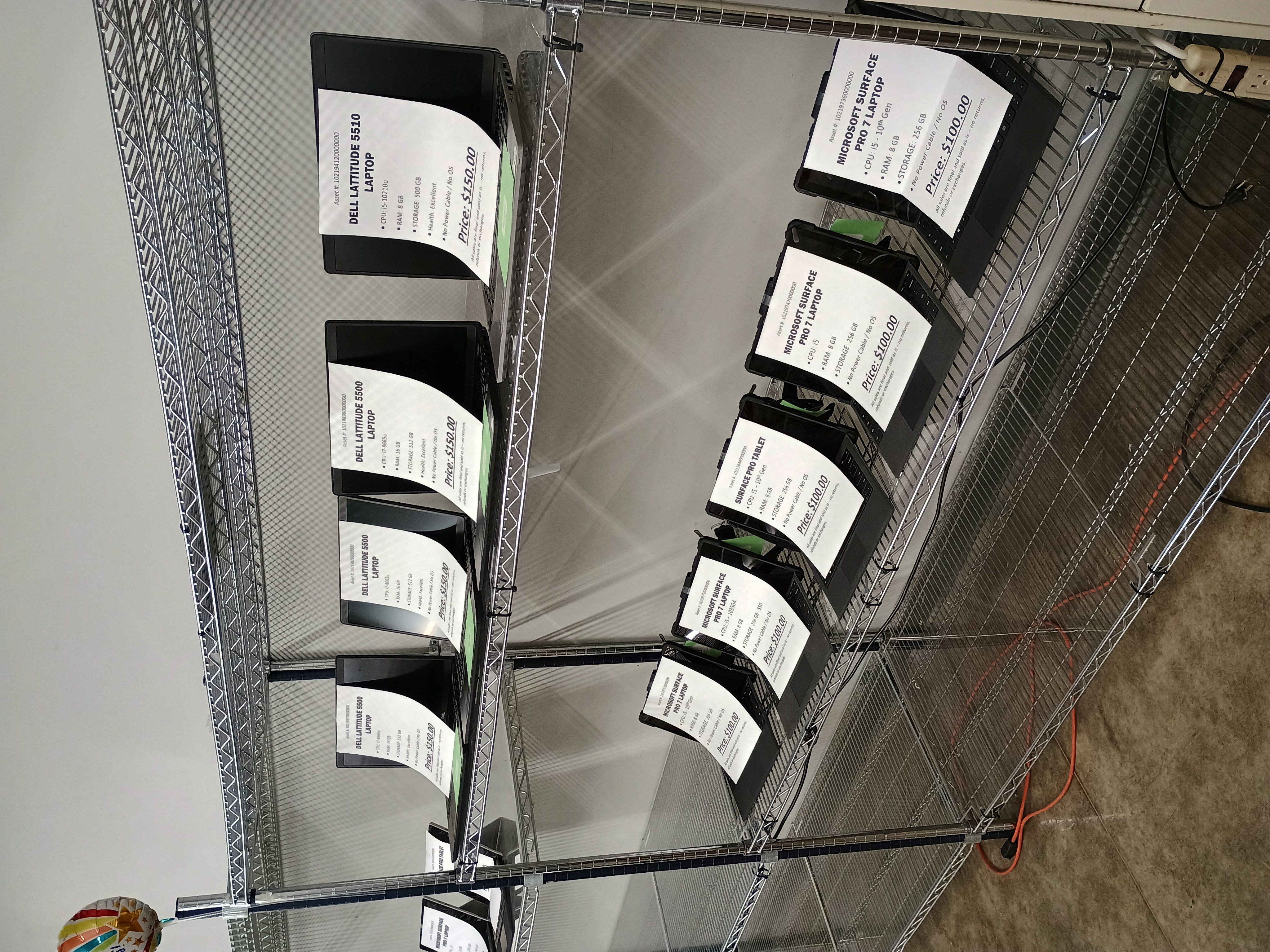 Four Tablets and four laptops on wire shelving.jpg