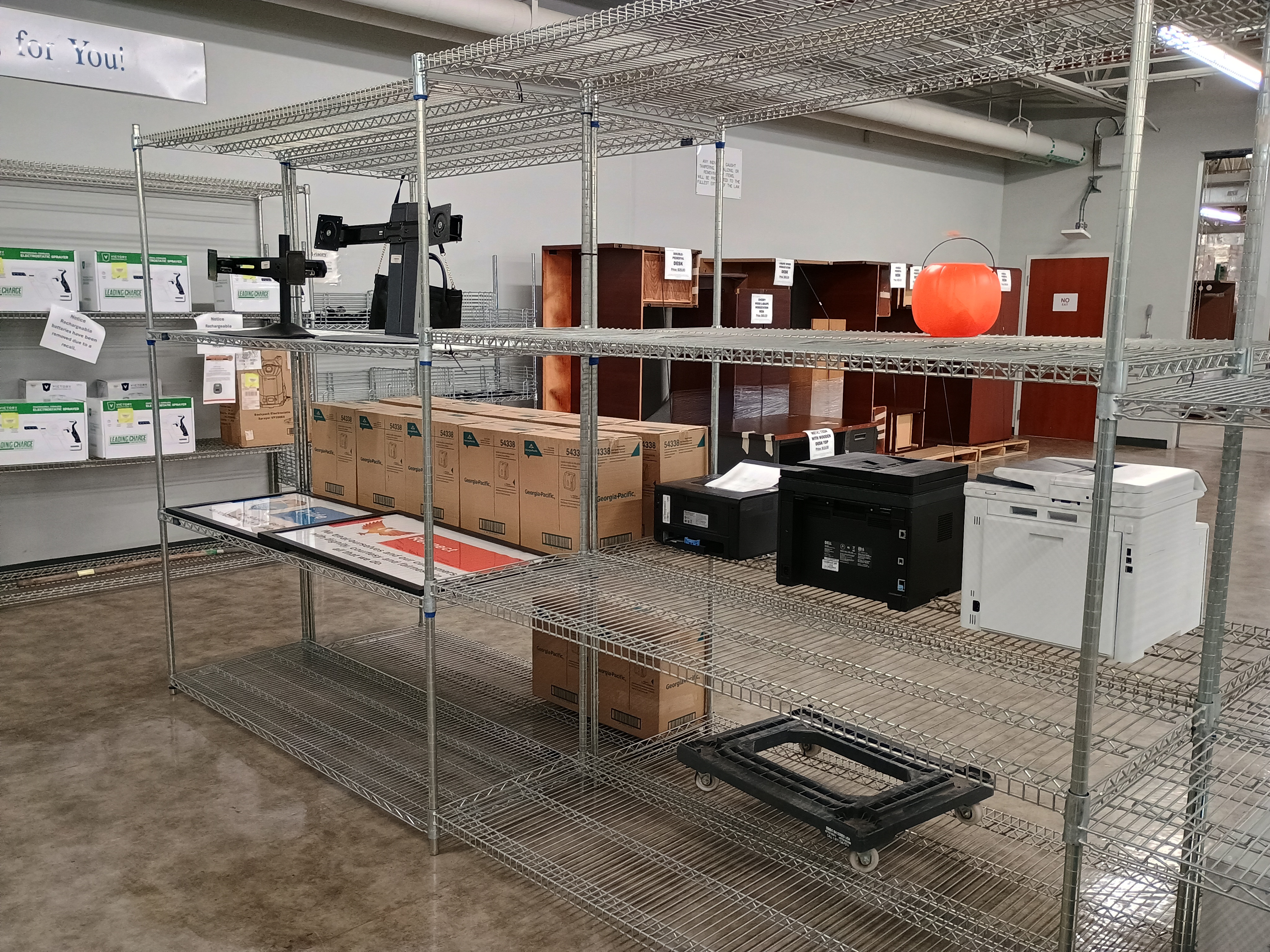 Metal wire racks with various merchandise, Printers, pumpkin pail, paper towel dispensers, poster frames, plastic dolly.jpg