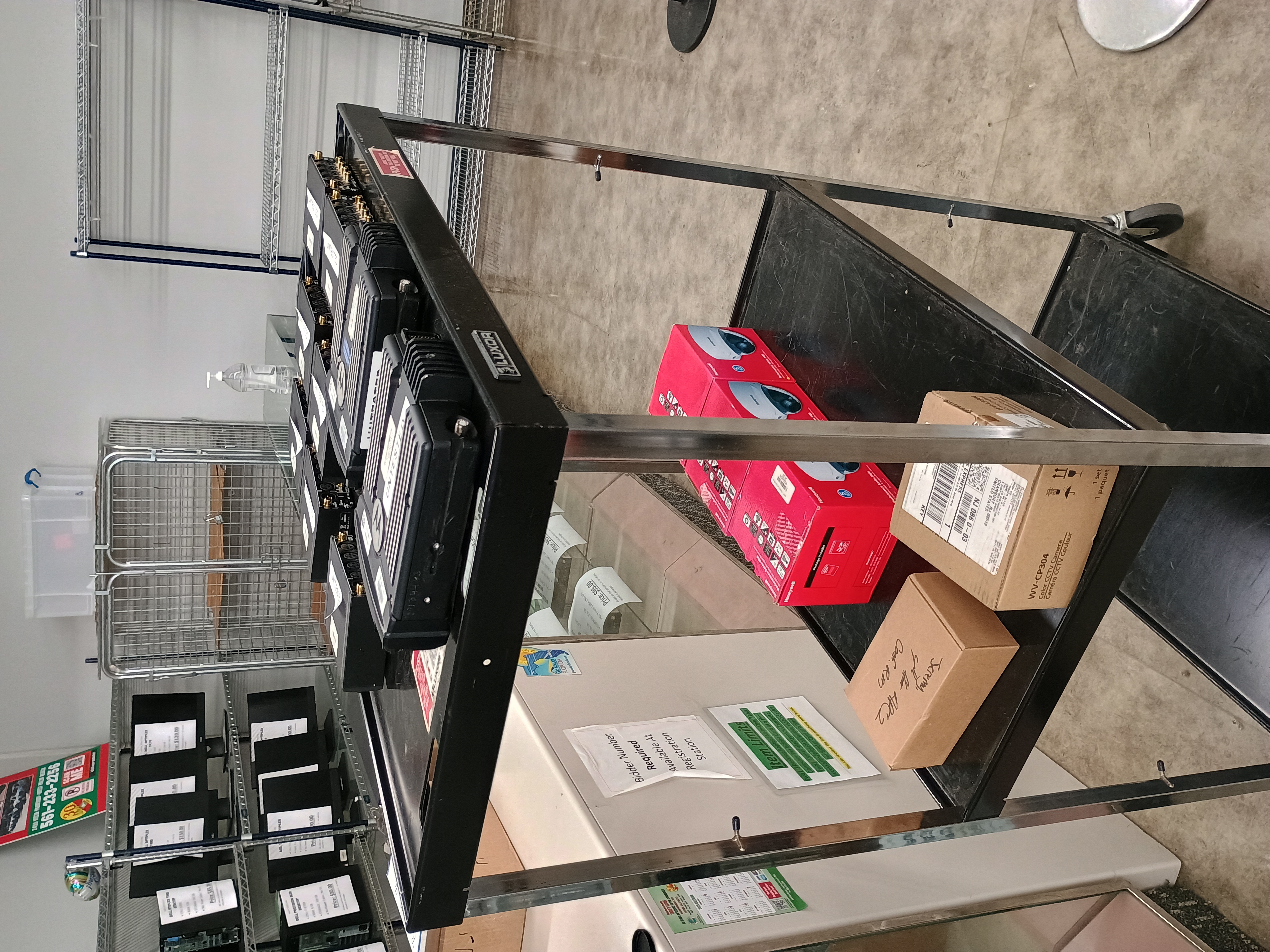 Mobile three tier metal cart with various miscellaneous electronics.jpg