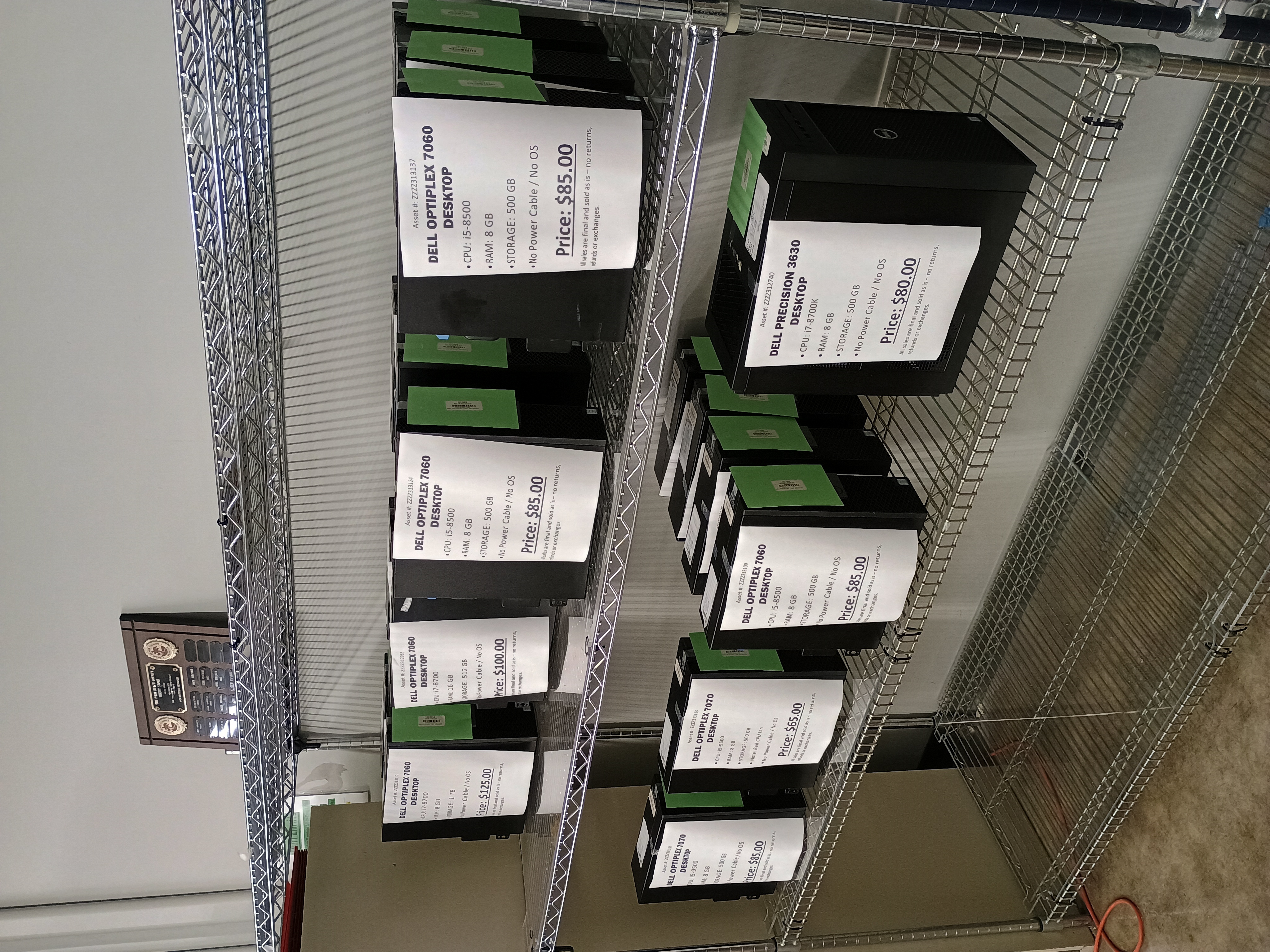 Several desktop computers on wire shelving.jpg