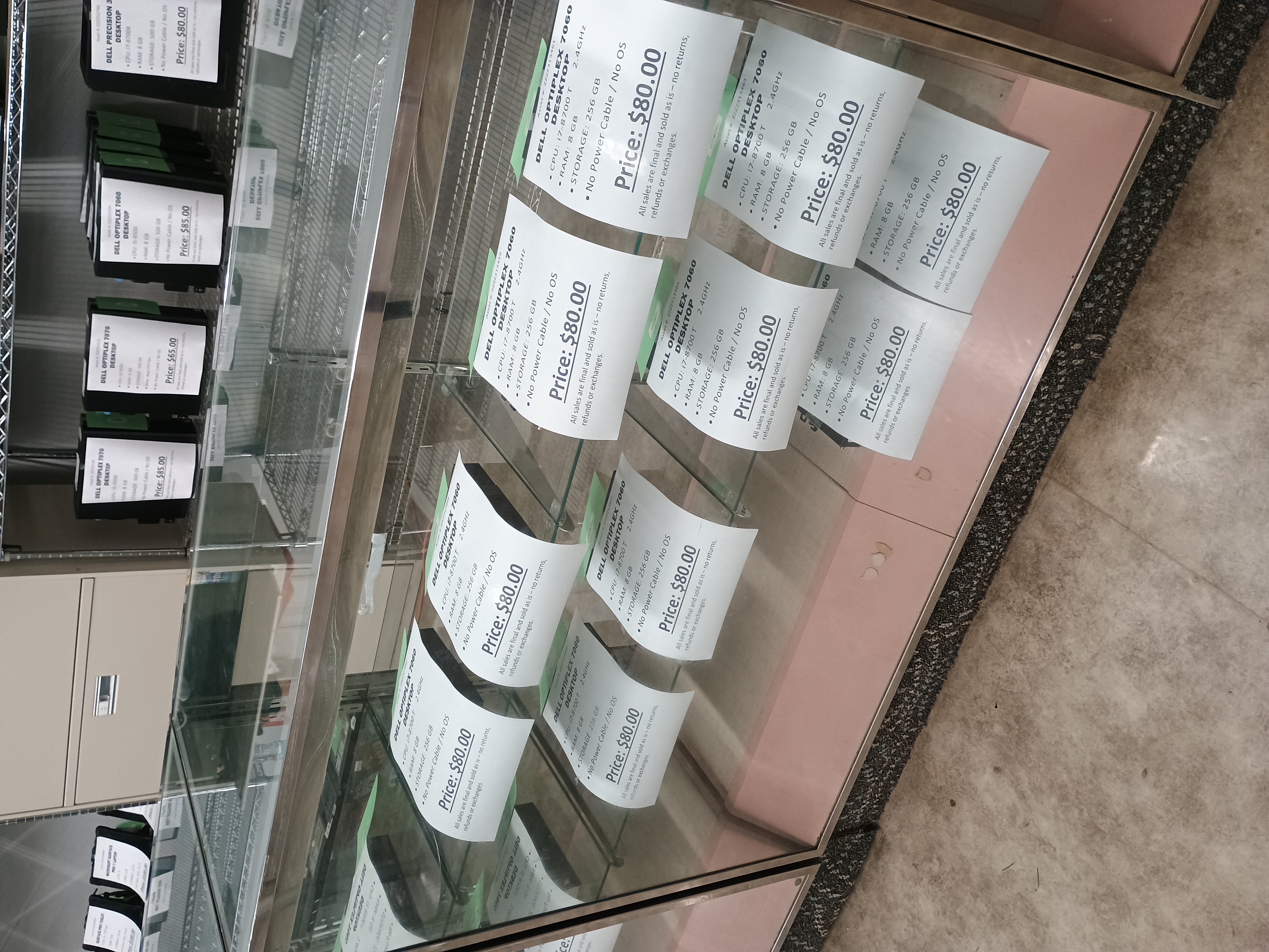Ten micro desktops in a glass display counter.jpg