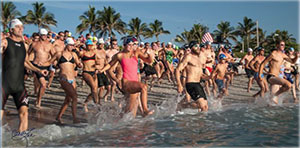swimmers running towards ocean