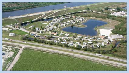 Aerial view of campers parked around lake.