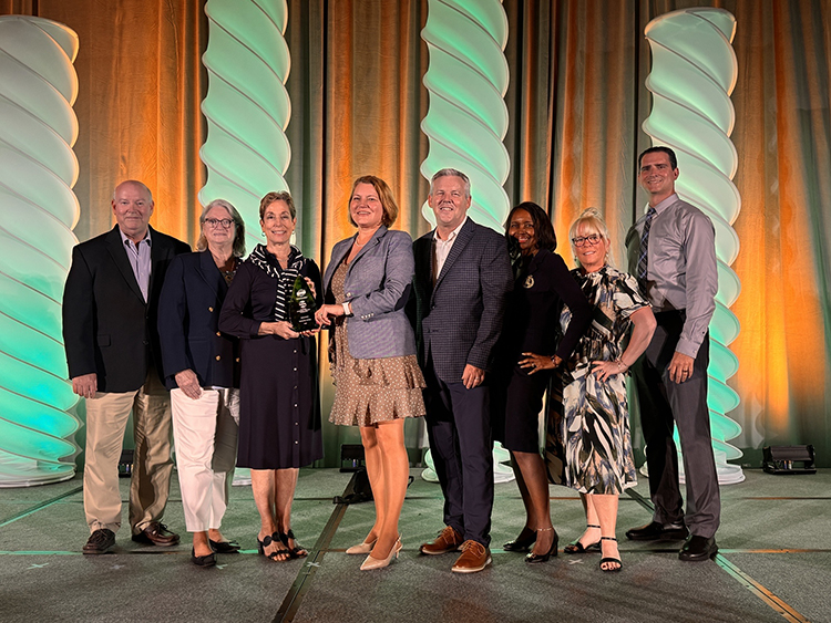 palm beach county officials standing together holding a plaque acknowledging CAPRA accreditation