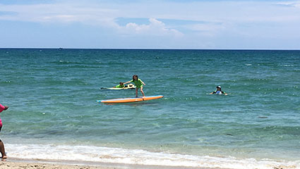 Youths learning to windsurf