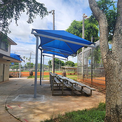 benches under shade structure at sports field