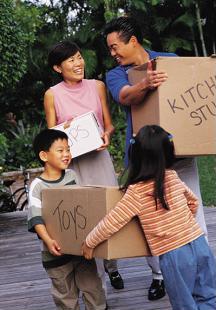 Couple and two children moving boxes